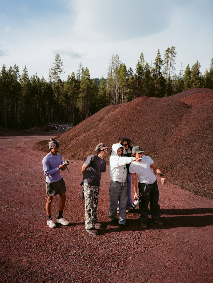 Five people looking at something one of the people is pointing at