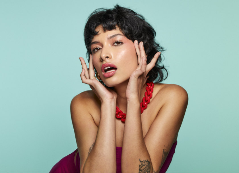 Female model wearing red necklace posing