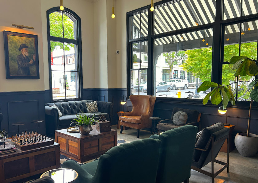 The lobby at the Atticus Hotel, with windows looking outside.