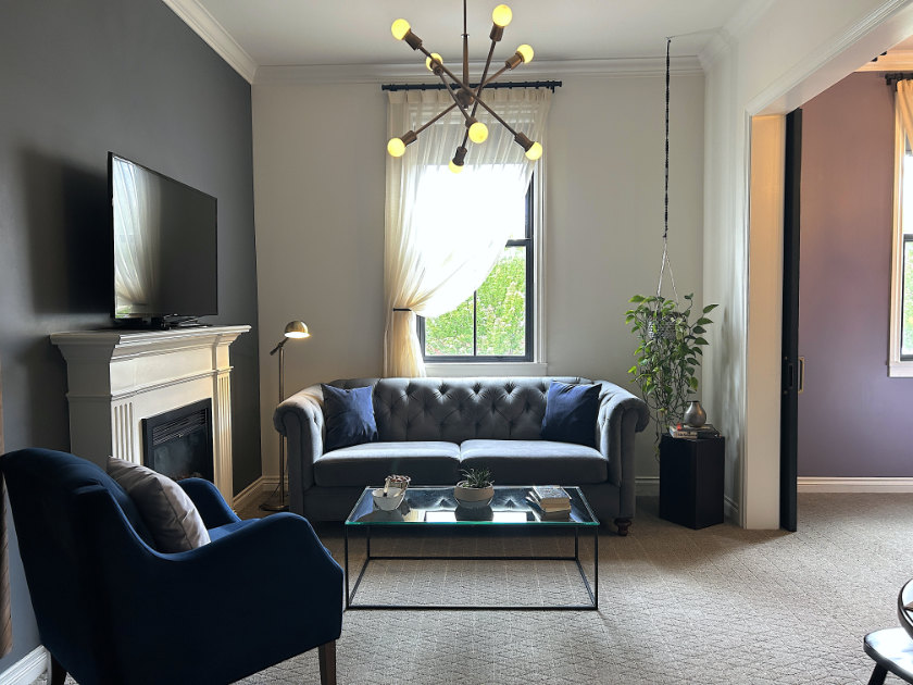 Inside the Atticus Hotel suite, in the living room area with couch and coffee-table.