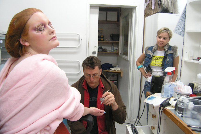 A model, Sir Richard Taylor applying make-up effects, and Mandi Kingsbury