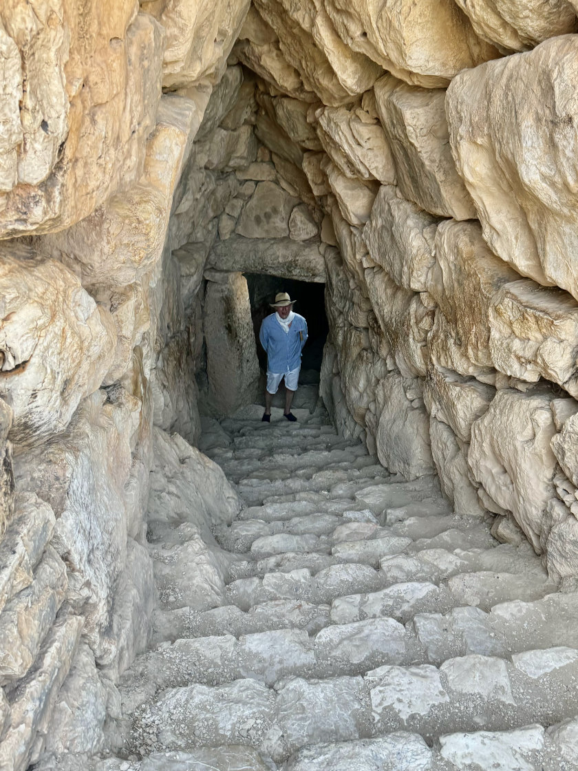 Passage to cistern at Mycenæ. Figure standing at the doorway down a flight of steps.