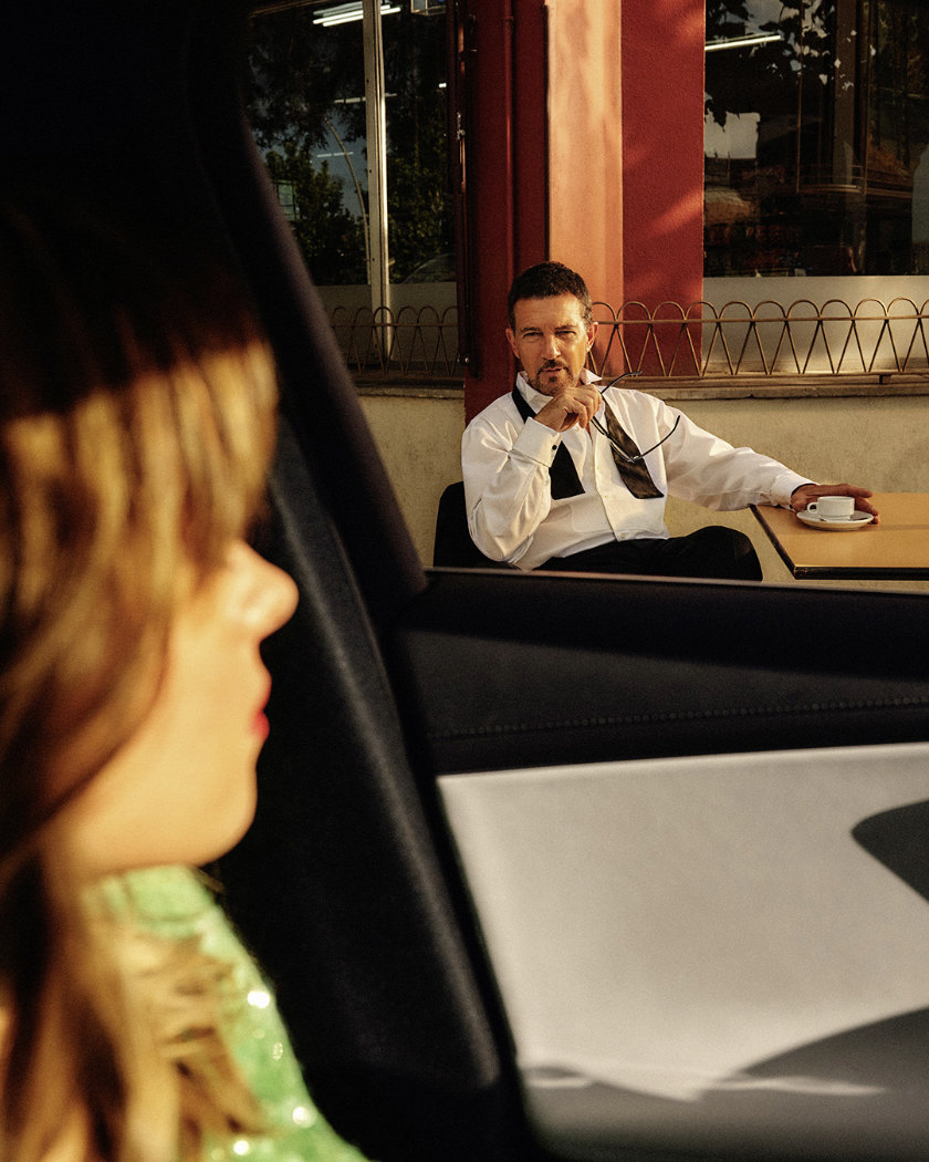 Stella Banderas in the foreground, looking out of her car window at her father