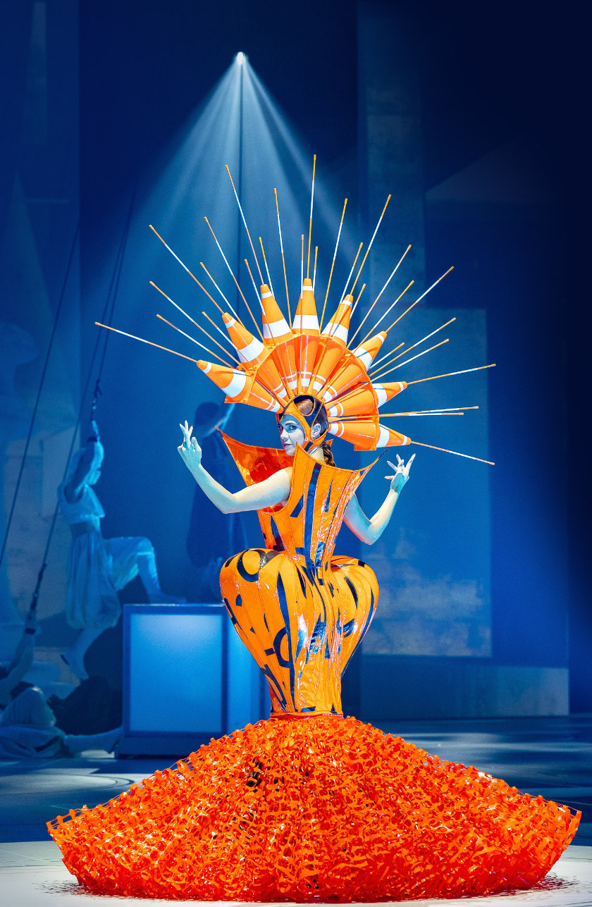 Curves Ahead, a startling orange wearable art garment, on stage